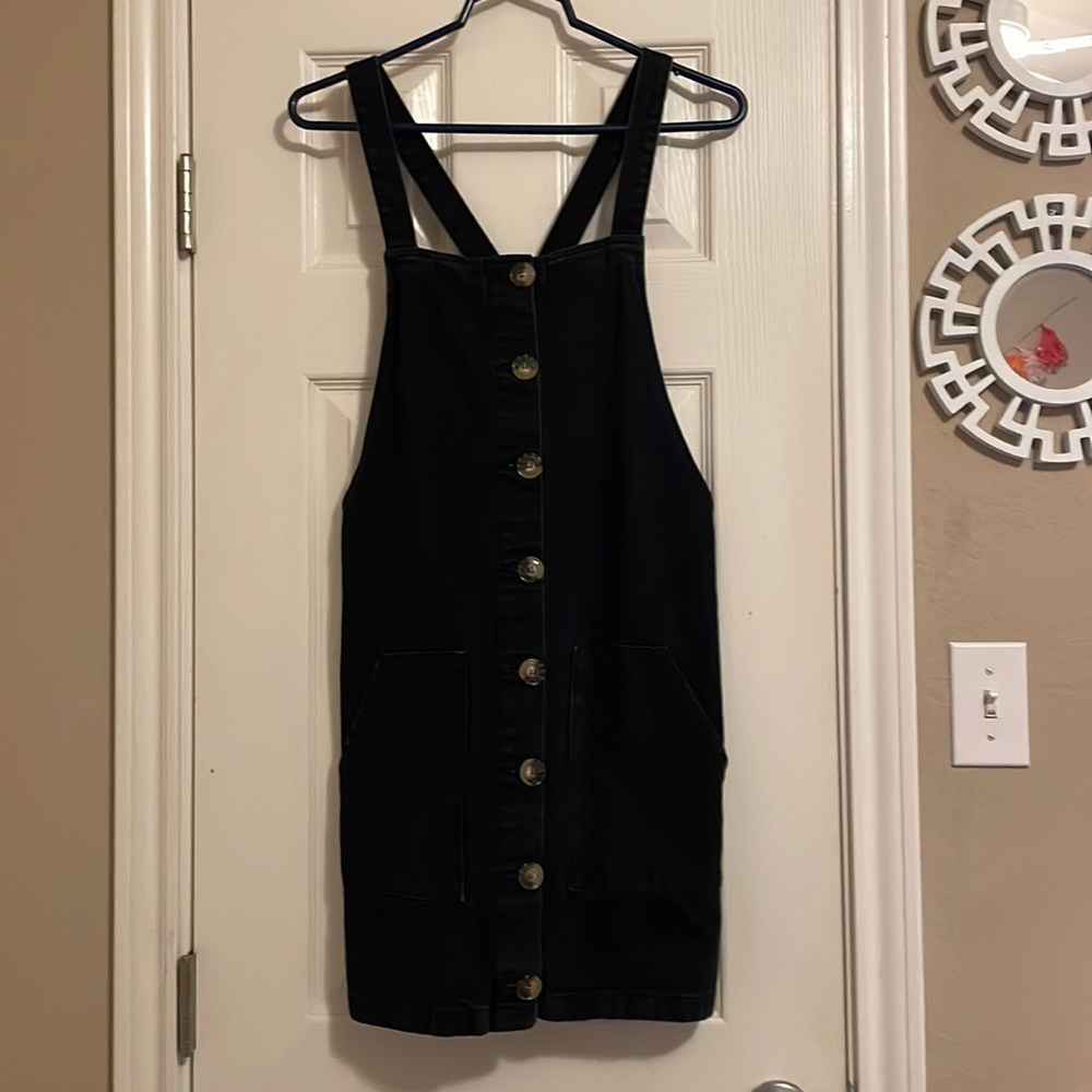 A black, over rolls with buttons all up the front and with 2 pockets on the side